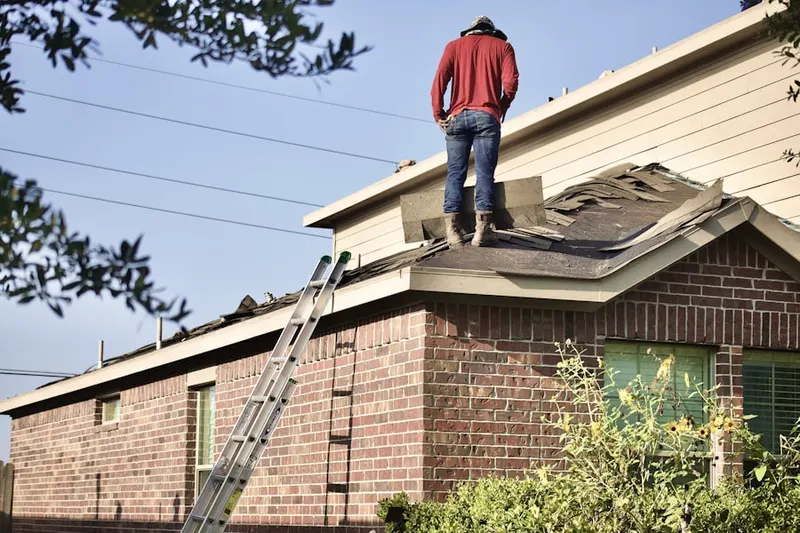 Professional roofer working on a residential roof in Wedgewood Golf and Country Club